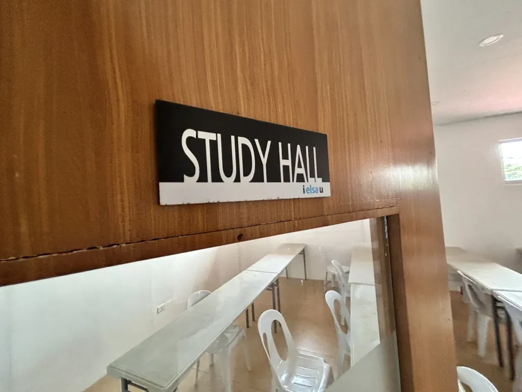 필리핀 세부 엘사(ELSA) 어학원 국제학교 부대시설로, STUDY HALL 팻말이 붙은 나무 벽 너머 책상과 의자가 놓인 자습실 풍경입니다.